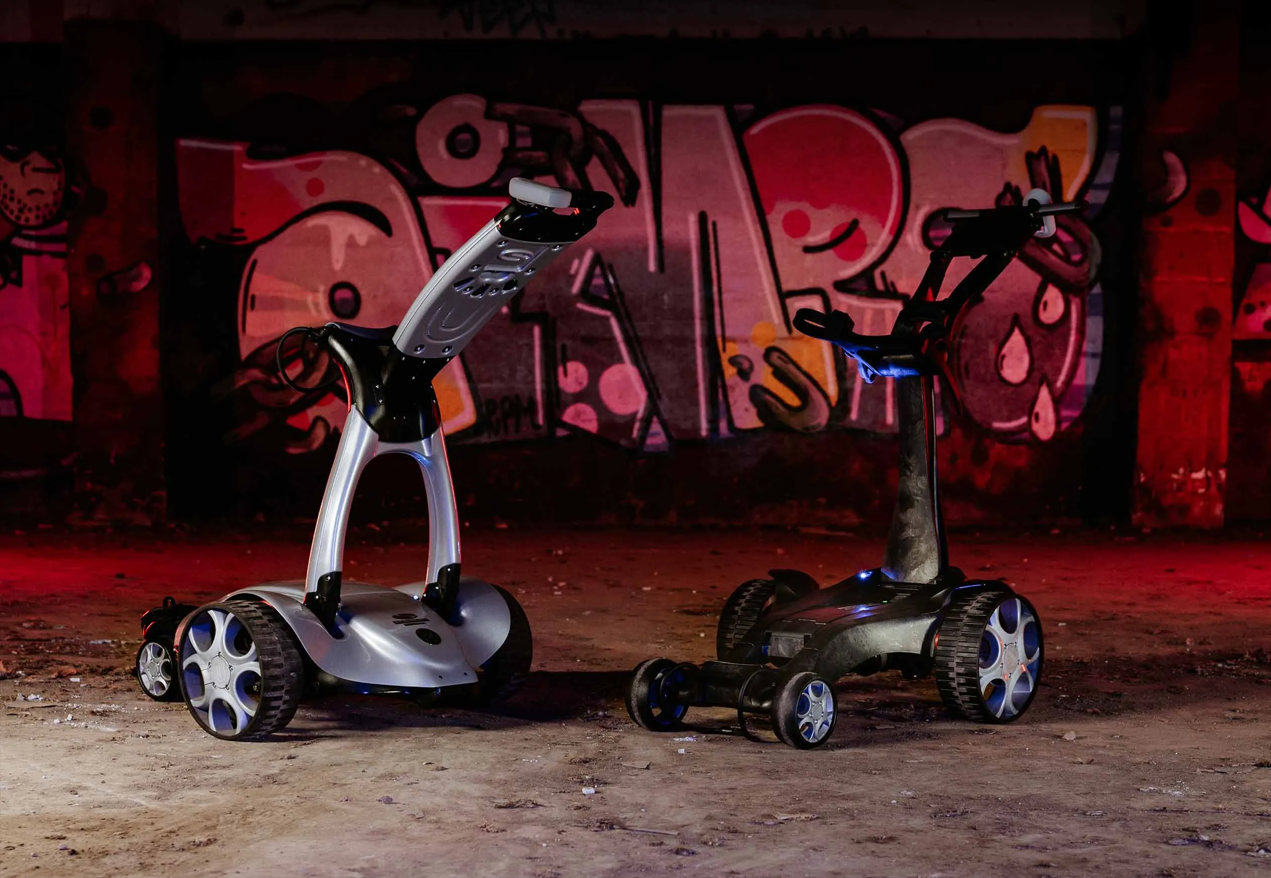 Two Stewart Golf Trolleys in graffiti scence