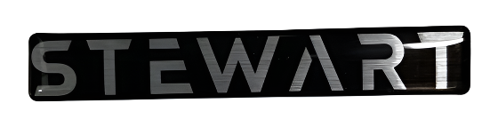 Metallic 'STEWART' logo on a reflective surface